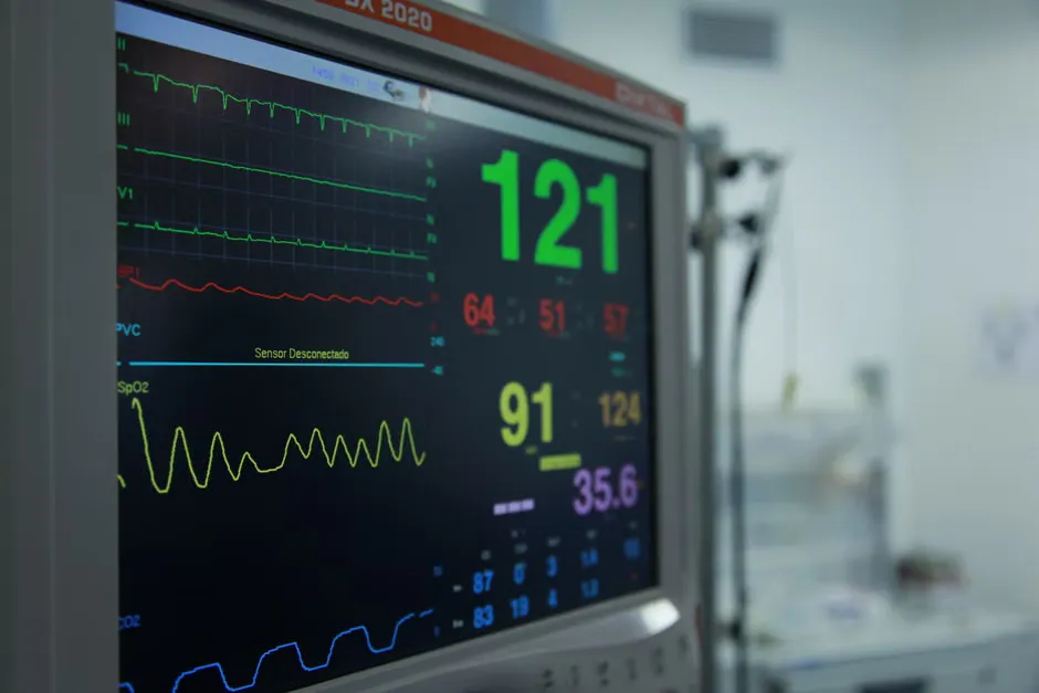 Monitor in a hospital communications room showing a hub diagram with the nurse call platform at the centre, linked to EMR/EHR, smart beds, RTLS, mobile, telephony, building management, reporting and other systems