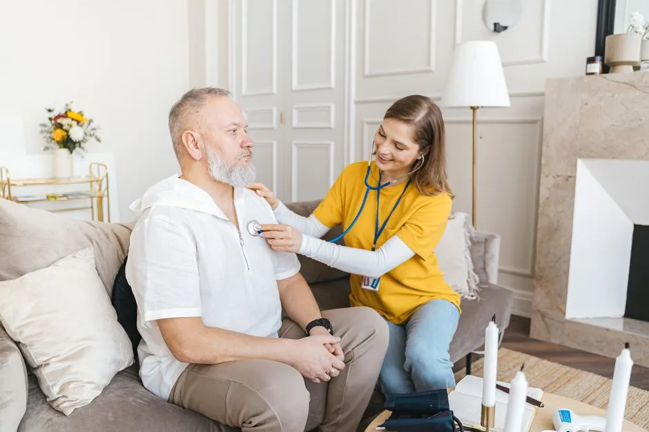 Carer responding to an overdoor call light in an aged care corridor