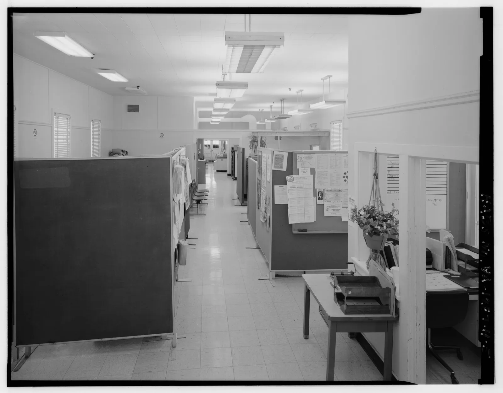Nurse at a ward station reviewing active calls on a wall-mounted display