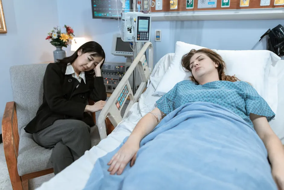 Bedside nurse call patient station with call and cancel buttons mounted beside a hospital bed
